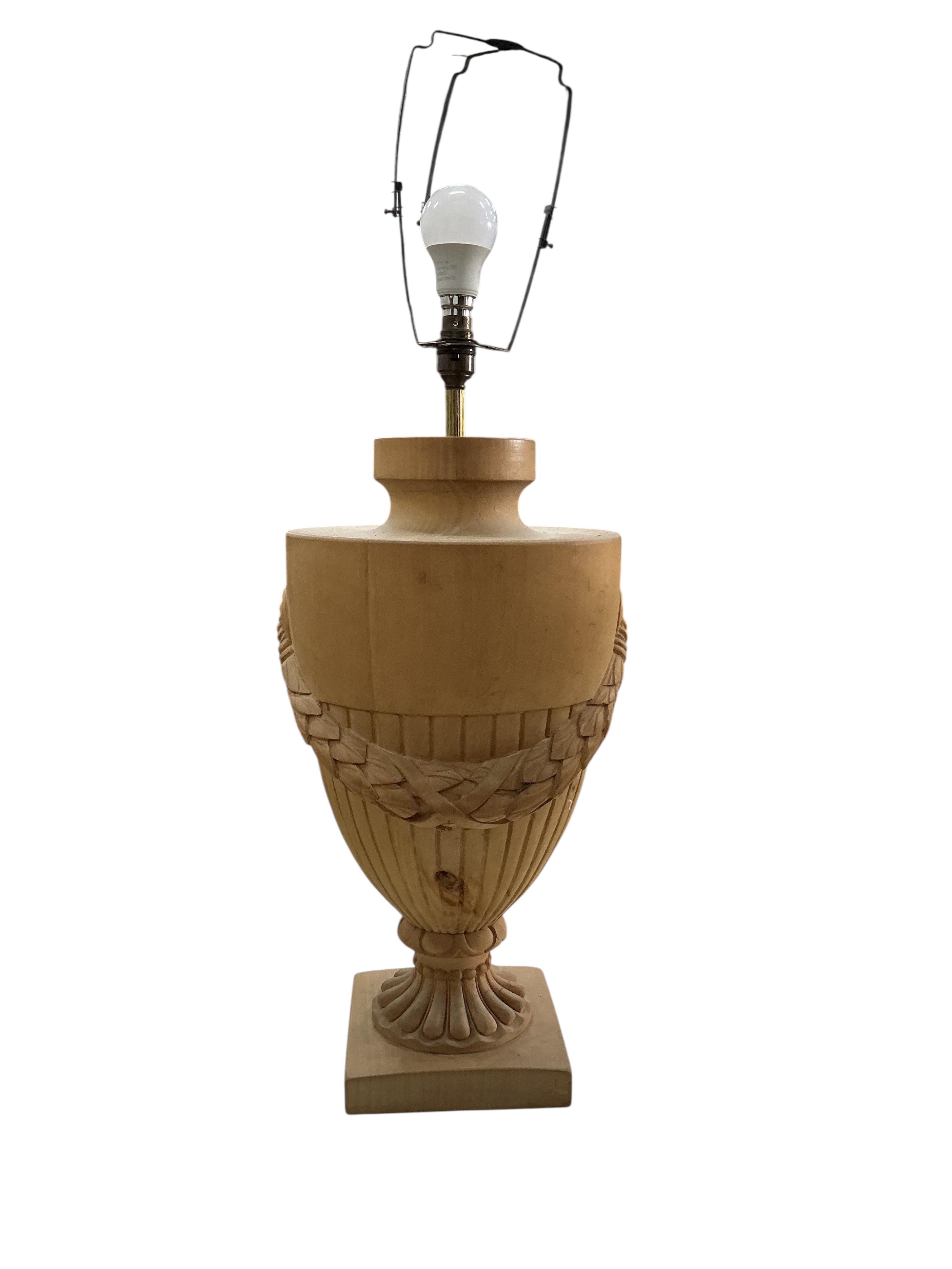 A pair of beech campana urn shaped lamps with shades, height including shades 90cm, Provenance: The late Kenneth Turner (1936-2025), celebrity florist, designer and perfume retailer, he received the Royal Warrant from th
